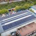 Aerial view of Sunergy Renewables solar panels on a commercial building roof