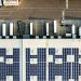 Aerial view of solar panels on a warehouse roof beside lorry loading bays